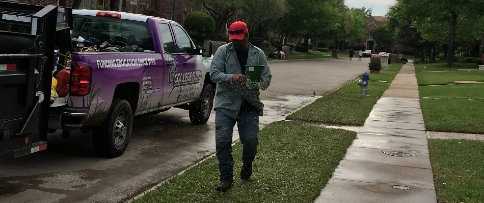 Professional lawn care company in Plano, TX, applying fertilizer to lawn.