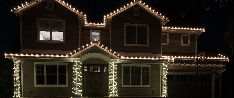 White Christmas lights decorating a home in Plano, TX.